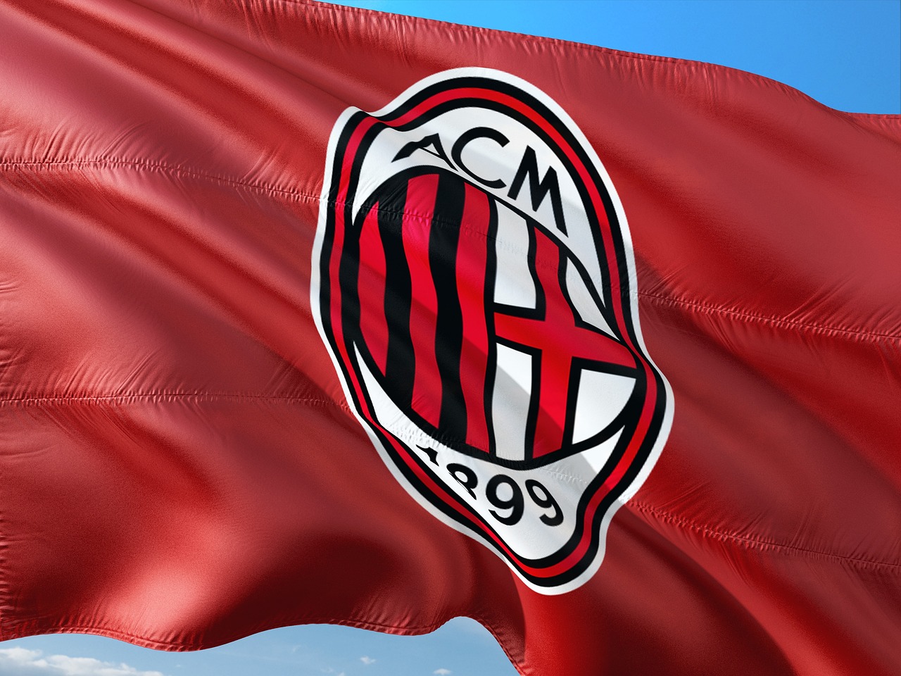 Bordowa, powiewająca flaga z logo AC Milan