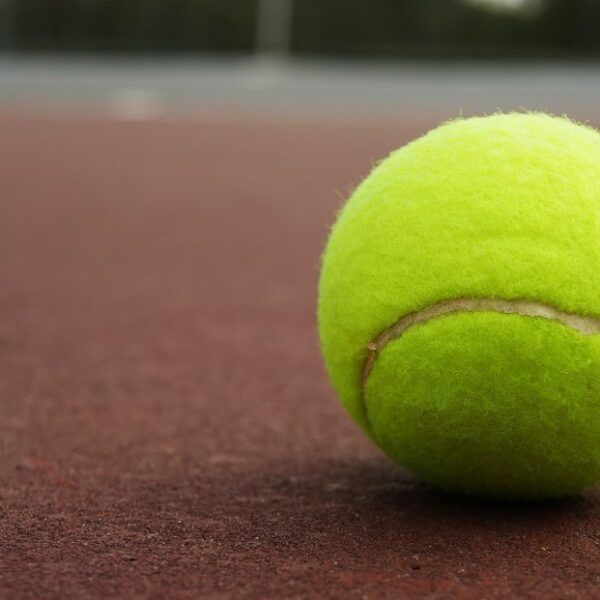 Zbliżenie na piłkę tenisową na nawierzchni ziemnej